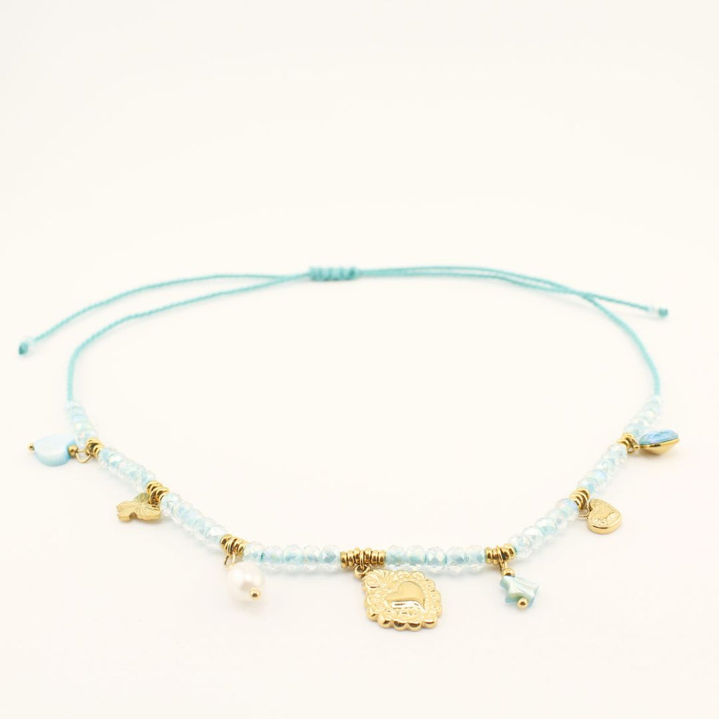 Collana con ciondoli dorati, perline azzurre e charm centrale a moneta