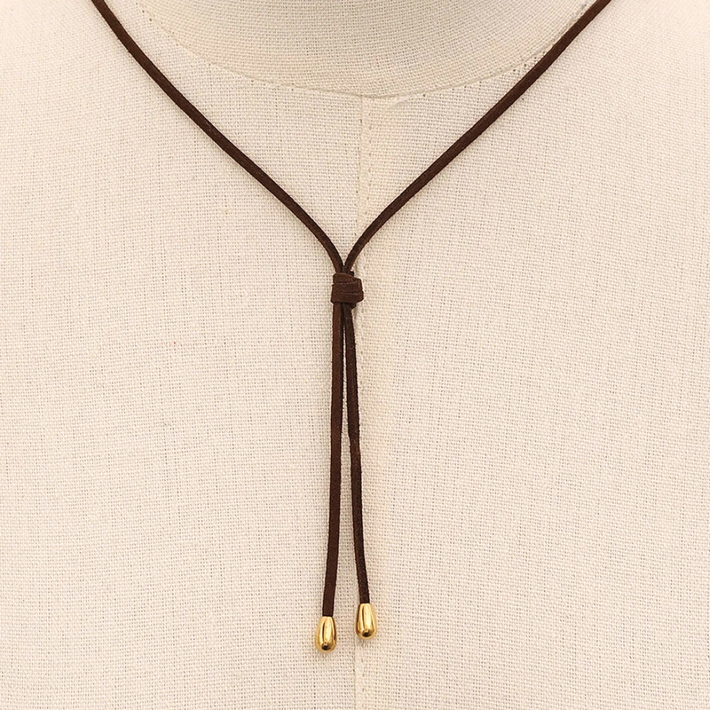 Collana con cordino marrone annodato e due piccoli terminali dorati, senza pendente.