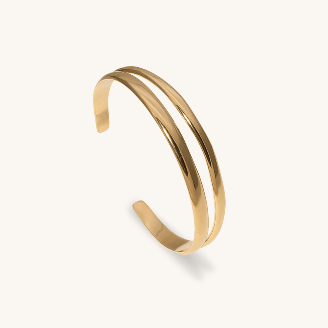 Bracciale rigido Succu oro 18k waterproof design doppio filo organico su sfondo crema Unique et Spécial