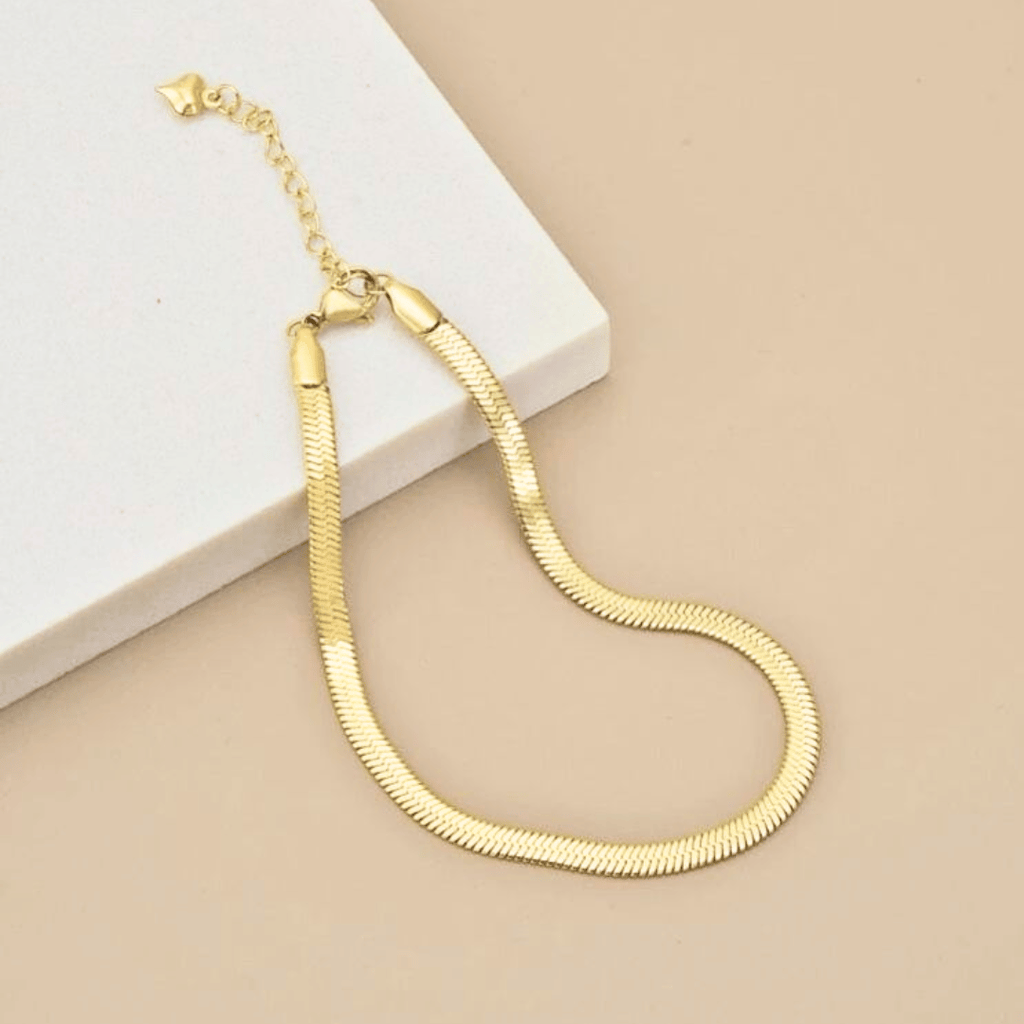 Bracciale dorato a maglia serpente con chiusura ad ardiglione e fibbia