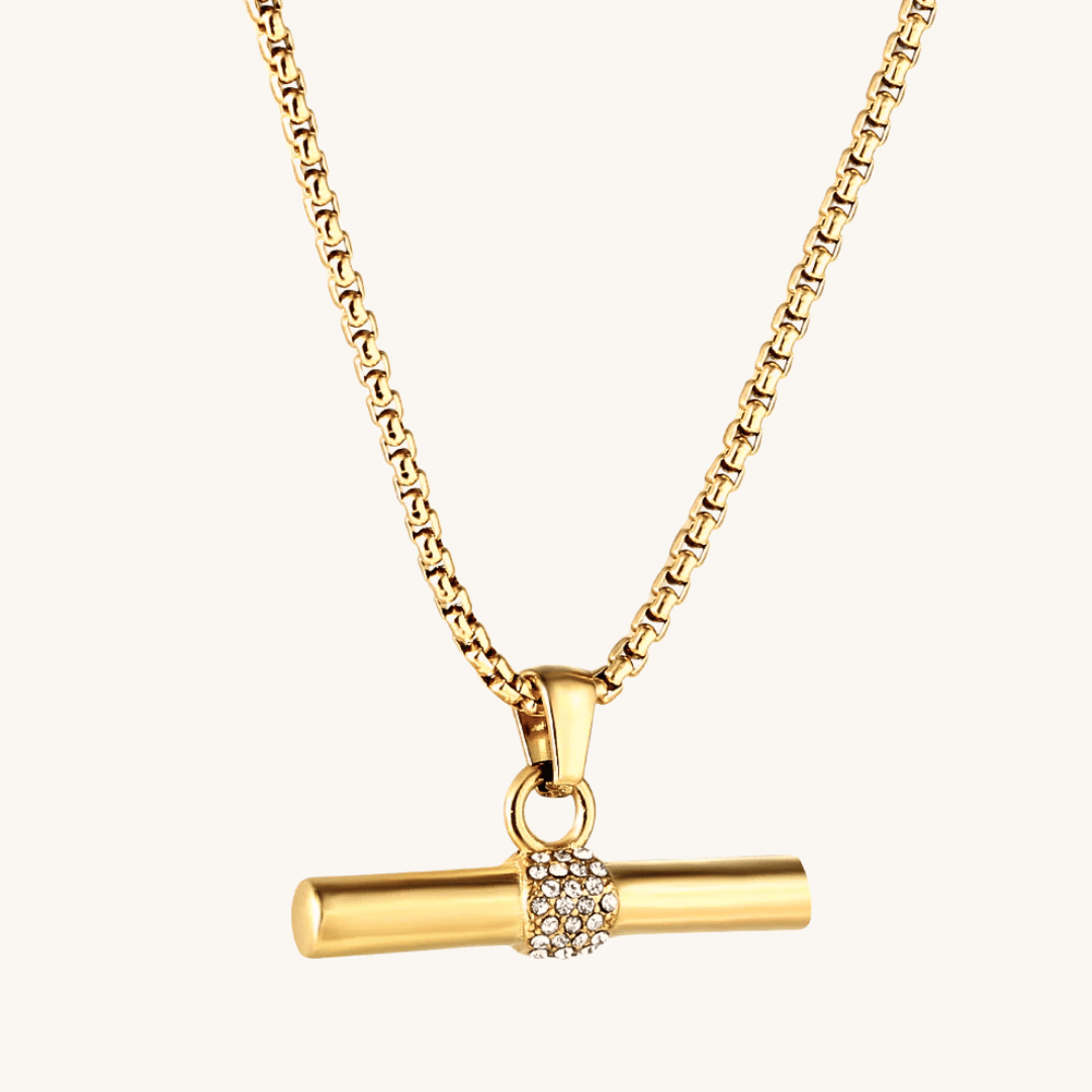 Collana dorata con ciondolo a cilindro e zirconi, con anello centrale